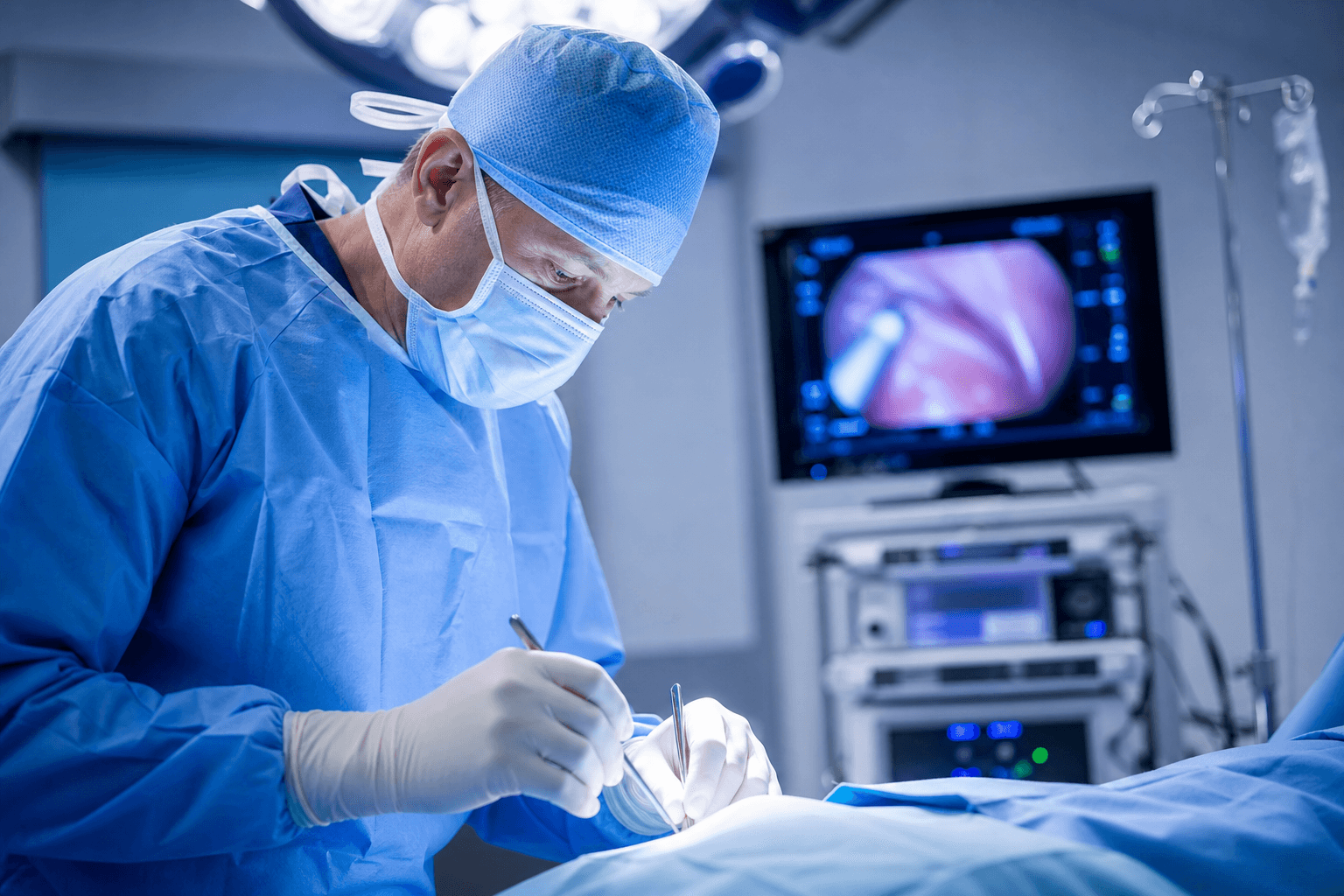 Surgeon performing a joint replacement procedure in the operating room